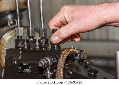 Professional Mechanics Testing Diesel Injector In His Workshop, Repair And Diagnostics Equipment, Soft Focus