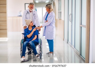 Professional Medical Doctor Team With Stethoscope In Uniform Discussing With Patient Woman With Cancer Cover Head With Headscarf Of Chemotherapy Cancer In Hospital.health Care Concept