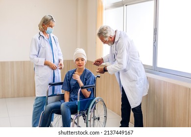 Professional Medical Doctor Team With Stethoscope In Uniform Discussing With Patient Woman With Cancer Cover Head With Headscarf Of Chemotherapy Cancer In Hospital.health Care Concept