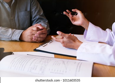 Professional Medical Doctor In White Uniform Gown Coat Interview Consulting Patient.