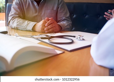 Professional Medical Doctor In White Uniform Gown Coat Interview Consulting Patient.