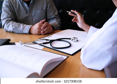 Professional Medical Doctor In White Uniform Gown Coat Interview Consulting Patient.