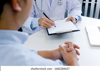 Professional Medical Doctor In White Uniform Gown Coat Interview Consulting Patient