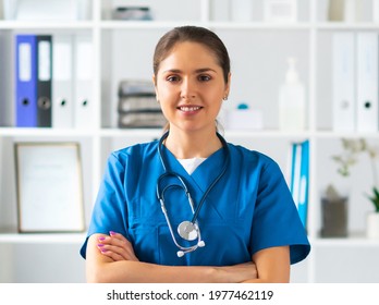 Professional medical doctor working in hospital office, Portrait of young and attractive female physician in protective mask. - Shutterstock ID 1977462119