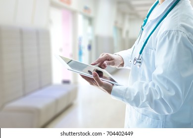 Professional medical physician doctor white uniform gown coat stethoscope hands holding digital patient chart information computer tablet in clinic hospital.Digital healthcare/ technology concept. - Powered by Shutterstock