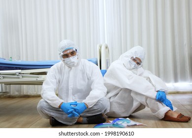 Professional Medical Team In Personal Protective Equipment Or PPE Cloth Sitting And So Tried After Treat Patients Infected With The Covid 19 Virus And Treatment In Lab Of Hospital In Thailand