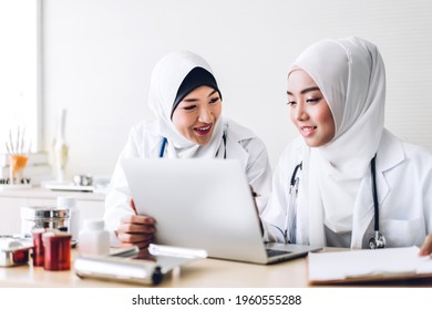 Professional Medical Two Muslim Asian Woman Doctor Team With Stethoscope In Uniform Working With Laptop Computer On Desk In Hospital.healthcare And Medicine