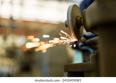 Professional metal work worker sharpening and grinding metal pipe. Man grinds metal profile in factory. - Powered by Shutterstock