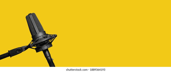 Professional microphone isolated on yellow background, podcast or website banner with copy space - Shutterstock ID 1889364193