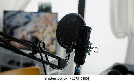 Professional Microphone On Stand Installed In Home Studio. High Tech Recording Condenser Podcast Device On Empty Living Room Equipped With Electronic Streaming Equipment. Close Up