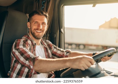 Professional middle aged truck driver in casual clothes driving truck vehicle going for a long transportation route. - Powered by Shutterstock