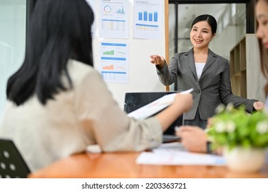 Professional Millennial Asian Female Boss Or CEO Training, Coaching And Mentoring To Her Employees. Businesspeople In The Meeting.