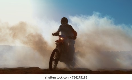 Professional Motocross Motorcycle Rider Drives Through Smoke And Mist Over The Dirt Road Track.