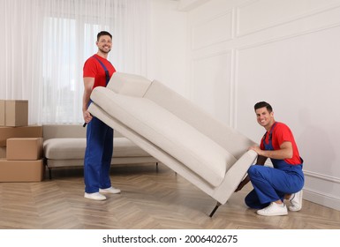 Professional Movers Carrying Sofa In New House