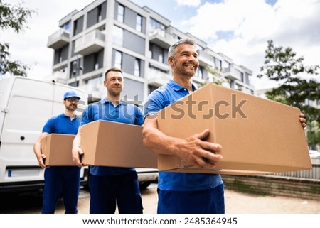 Professional Movers Loading Van with Blue Boxes, Mature Caucasian Man Smiling and Carrying Furniture into New House.