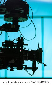 Professional Movie Camera Shooting  On Set With Blue Background, Stabilized Video Camera On A Crane