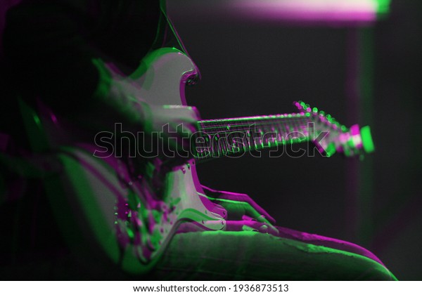 Professional musician playing electric guitar\
on stage edited with 3d stereo effect.Guitarist play live set on\
rock concert in music hall.Download royalty free curated images\
collection with\
musicians