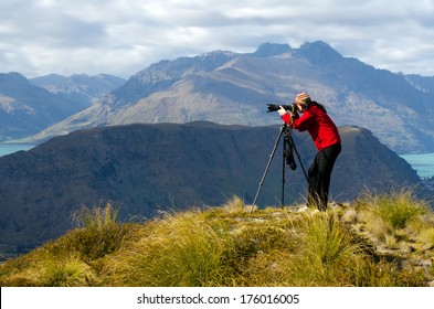 Professional Nature Landscape And Wildlife Photographer (woman) Photographing The Outdoor Landscape View Of The South Island Of New Zealand.Real People. Copy Space