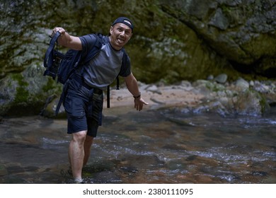 Professional nature photographer with backpack taking shots in a gorge - Powered by Shutterstock