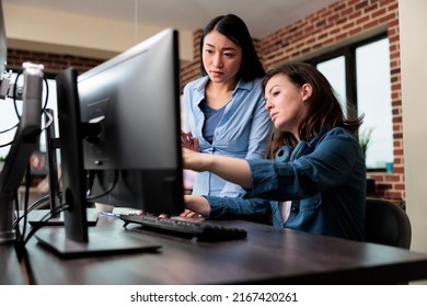 Professional office workers pointing out wrong blueprint of project while using work computer. Creative designers developing digital arts on PC while discussing about 3D technology. - Powered by Shutterstock - Get 15% off with code: PIKWIZARD15