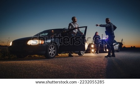 Professional Officer Ordering a Driver to Get Out of the Vehicle and Put His Hands on the Hood of his Car. Female Backup Cop Joins the Scene to Help her Partner. Potentially Fire-Armed Suspect