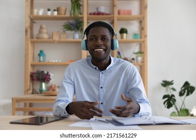 Professional On-line Counselling By Videocall, Business E-coach, Negotiations Use Videoconference Application Concept. Smiling African Businessman In Headphones Take Part In Virtual Meeting In Office