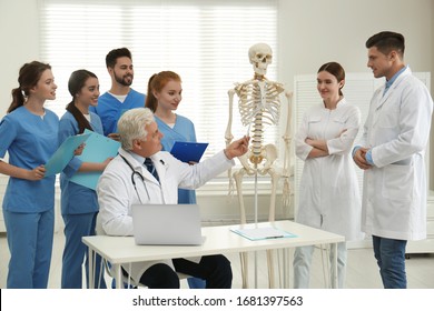 Professional Orthopedist Teaching Medical Students In Clinic