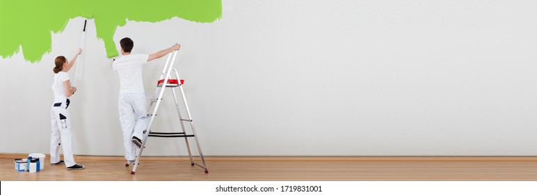 Professional Painter Man Painting Wall. Painter Couple