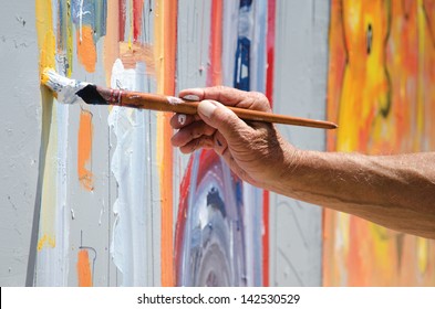 Professional painter at work, painting a street wall