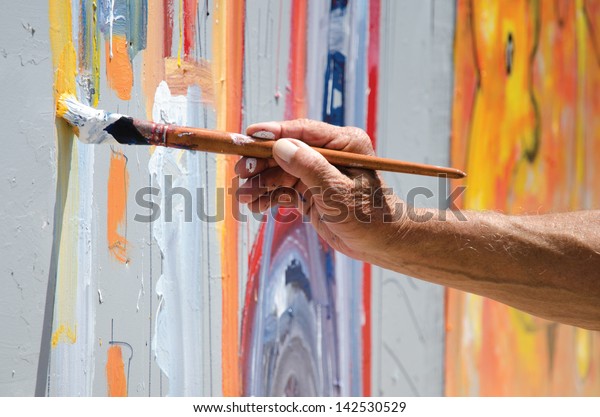 Professional\
painter at work, painting a street\
wall