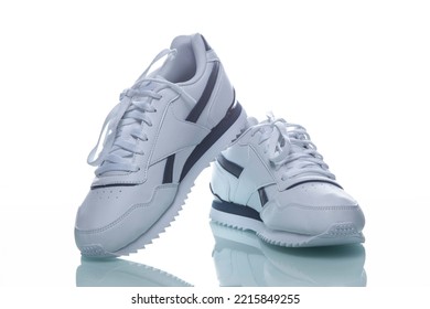 Professional Pair Of Of New White Sneakers Placed Against White Background. Horizontal Shot