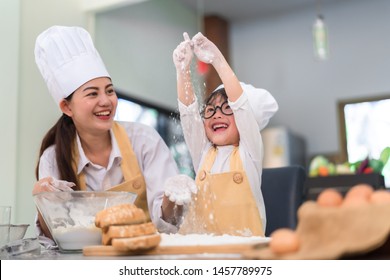 Professional Pastry Chef Asian Mom And Son Making Bakery Cake Prepare Delicious Sweet Food In The Kitchen Room For Dinner At Home Happy Family Lifestyle.