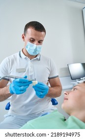 Professional Pediatric Dentist Conducting Restorative Dentistry Procedure