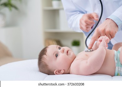 Professional Pediatrician Examining Infant 