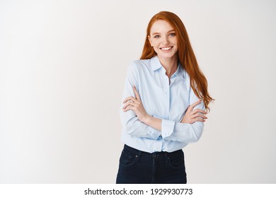 Professional People. Young Happy Redhead Woman Smiling At Camera, Cross Arms On Chest Confident, Standing In Office Blouse Over White Background