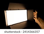Professional photo or video lighting. SRGB Led-panel on tripod for home or studio shooting. Adjusting light equipment.