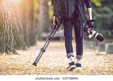 professional photographer with camera and tripod in autumn. Vintage tone. - Powered by Shutterstock