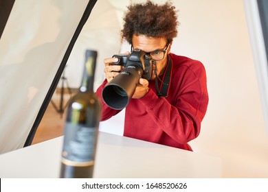 Professional Photographer Photographs A Bottle For Product Photography