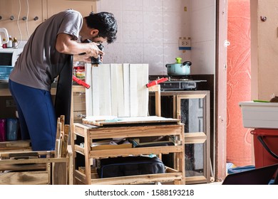 Professional Photographer Taking A Photo With Simple Natural Light Studio Set Up Inside Kitchen In A Narrow Space.