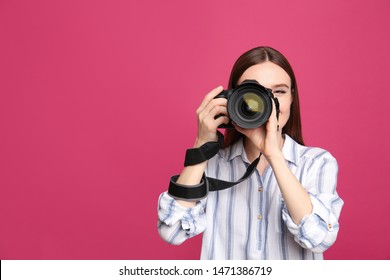 Professional photographer taking picture on pink background - Powered by Shutterstock