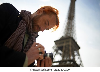 Professional photographer at work in the city centre of Paris near the Eiffel Tower