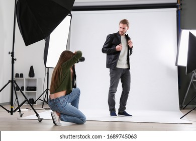 Professional photographer working with model in studio - Powered by Shutterstock