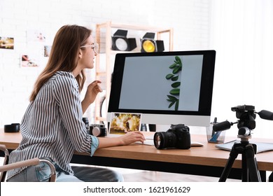 Professional Photographer Working At Table In Office