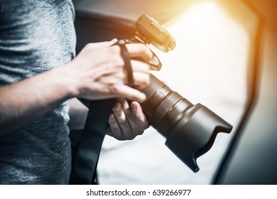 Professional Photography Job Concept  Photographer and Modern Digital Camera in Hand
