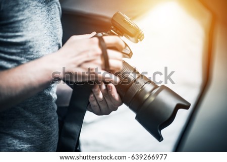Professional Photography Job Concept. Photographer with Modern Digital Camera in Hand
