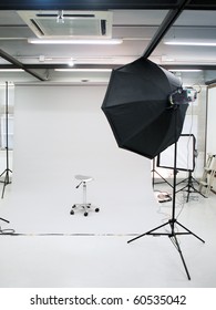 Professional Photography Studio Setup With Flash Lighting And White Background