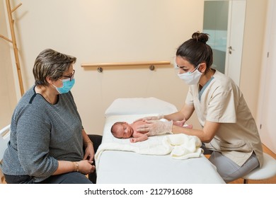 Professional Physical Therapist Working With The Diaphragm Of A Newborn Baby.