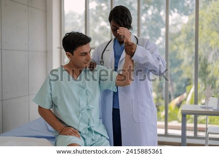 Professional physiotherapist examining and care body to young man in rehabilitation physical center. African female doctor treating muscle and joint injuries to male in hospital. Orthopedic concept.