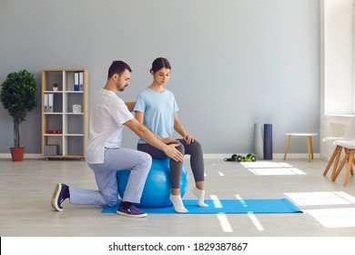 Professional physiotherapist or osteopath helping woman to fix body on fitness ball in right position for pain relief during visit in manual therapy clinic. Cchiropractor during work concept - Powered by Shutterstock