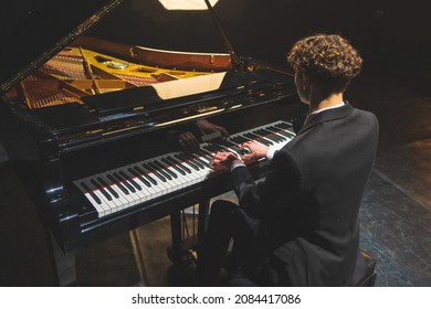 Professional pianist performing a piece on a grand piano